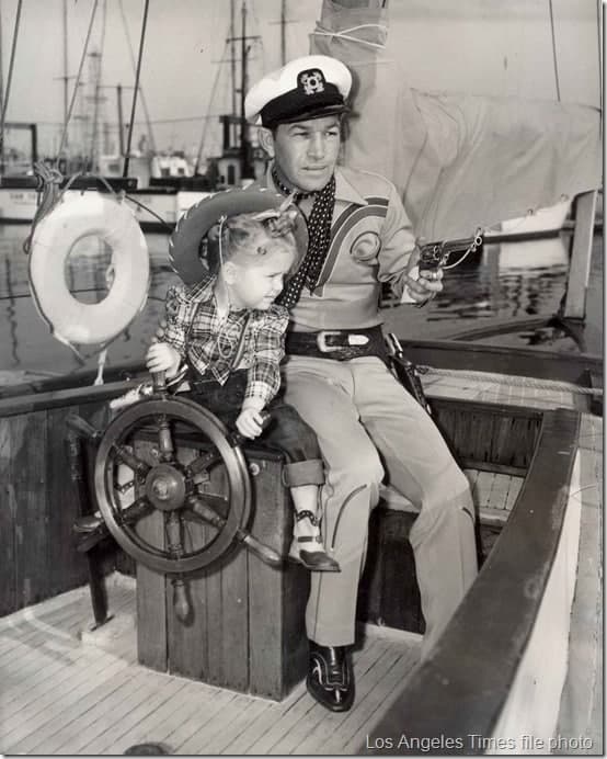 Spade Cooley and his daughter Melody pose for a publicity photo aboard his yacht.
