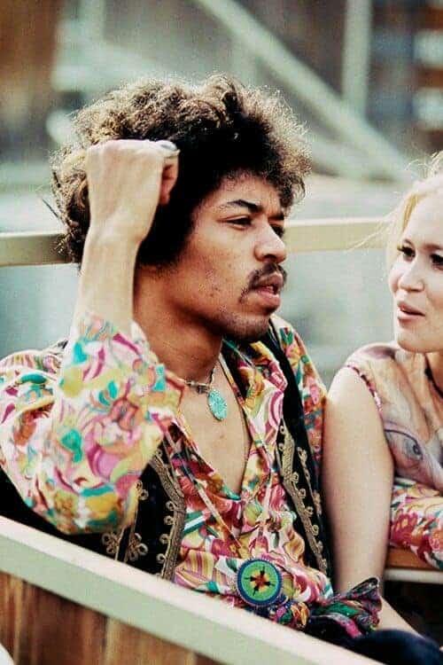 Jimi Hendrix sits next to Carmen Borrero in a Pool Box seat during afternoon sound check at the Hollywood Bowl, California, US, September 14, 1968. Photo by Ed Caraeff.